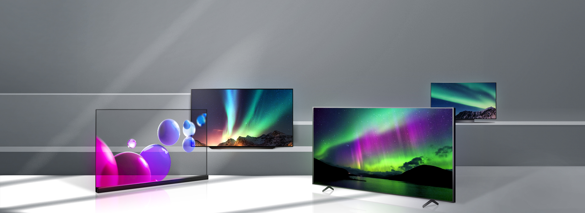 On the stairs are several TVs with OLED panels from LG display, with colorful graphic images floating on the screens.